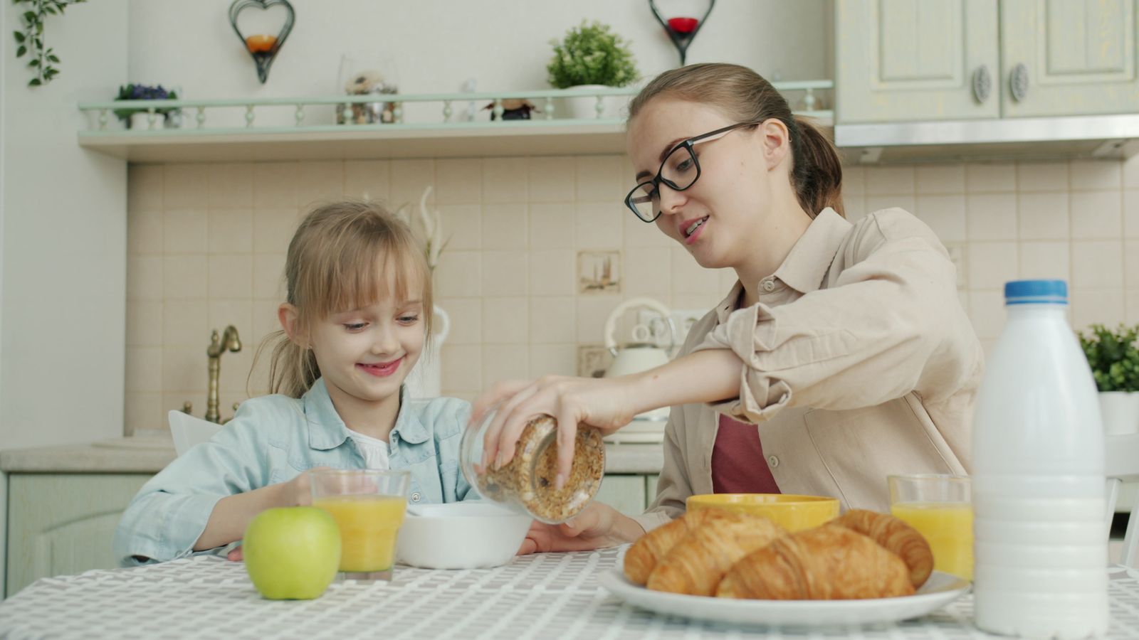 Mama i córka jedzą razem zdrowe śniadanie przed szkołą